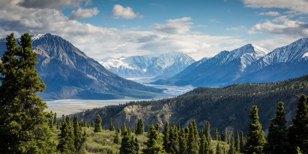 green mountain across body of water